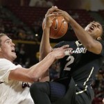 Colorado's Xavier Johnson (2) gets fouled by Arizona State's Eric Jacobsen, left, as he goes up for a shot during the first half of an NCAA college basketball game Saturday, Jan. 25, 2014, in Tempe, Ariz. (AP Photo/Ross D. Franklin)