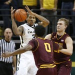 Oregon's Carlos Emory, left, tries to pass the ball under pressure from Arizona State's Carrick Felix and Jonathan Gilling during the first half of an NCAA college basketball game in Eugene, Ore. Sunday Jan. 13, 2013. (AP Photo/Chris Pietsch)