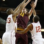 Arizona State's Jordan Bachynski, center, shoots over Southern California's D.J. Haley, left, and Julian Jacobs during the first half of an NCAA college basketball game, Thursday, Jan. 9, 2014, in Los Angeles. (AP Photo/Danny Moloshok)