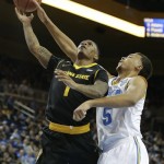 UCLA guard Kyle Anderson, right, blocks a shot by Arizona State guard Jahii Carson during the first half of an NCAA college basketball game in Los Angeles, Sunday, Jan. 12, 2014. (AP Photo/Chris Carlson)