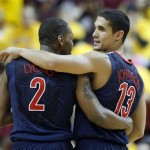 Arizona's Mark Lyons (2) and Nick Johnson (13) walk down the court with the game well in hand and two-minutes left against Arizona State during the second half of an NCAA basketball game, Saturday, Jan. 19, 2013, in Tempe, Ariz. Arizona won 71-54. (AP Photo/Ralph Freso)
