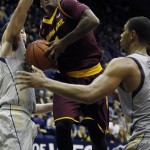 Arizona State's Jahii Carson, center, goes up between California's Sam Singer, left, and Richard Solomon during the second half of an NCAA college basketball game, Wednesday, Jan. 29, 2014 in Berkeley, Calif. (AP Photo/George Nikitin)