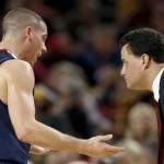 Arizona's T.J. McConnell (4) talks with head coach Sean Miller during the first half of an NCAA college basketball game against Arizona State, Friday, Feb. 14, 2014, in Tempe, Ariz. (AP Photo/Ross D. Franklin)