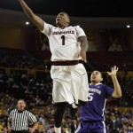  Arizona State guard Jahii Carson (1) drives and scores past Washington guard Nigel Williams-Goss (5) during the second half of an NCAA basketball game, Thursday, Jan. 2, 2014, in Tempe, Ariz. The Huskies defeated the Sun Devils 76-65. (AP Photo/Rick Scuteri)