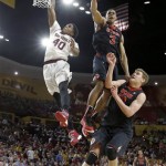 Utah's Princeton Onwas (3) collides with teammate Dallin Bachynski, right, after blocking the shot of Arizona State's Shaquielle McKissic during the second half of an NCAA college basketball game Thursday, Jan. 23, 2014, in Tempe, Ariz. Arizona State defeated Utah 79-75. (AP Photo/Ross D. Franklin)