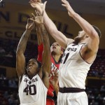 Arizona State's Eric Jacobsen, right, and Shaquielle McKissic (40) defends against a shot by UNLV's Patrick McCaw, middle, during the second half of an NCAA college basketball game Wednesday, Dec. 3, 2014, in Tempe, Ariz. Arizona State defeated UNLV 77-55. (AP Photo/Ross D. Franklin)