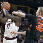 Arizona State's Savon Goodman (11) is fouled as he drives to the basket by Oregon State's Olaf Schaftenaar during the second half of an NCAA college basketball game, Wednesday, Jan. 28, 2015, in Tempe, Ariz. Arizona State defeated Oregon State 73-55. (AP Photo/Ralph Freso)
