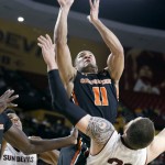Oregon State guard Malcolm Duvivier (11) collides with Arizona State's Eric Jacobsen (21) as he drives to the basket during the first half of an NCAA college basketball game, Wednesday, Jan. 28, 2015, in Tempe, Ariz. (AP Photo/Ralph Freso)
