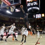 Oregon State guard Gary Payton II leaps to the basket over Arizona State defenders Eric Jacobsen (21) and Shaquielle McKissic, center, during the first half of an NCAA college basketball game, Wednesday, Jan. 28, 2015, in Tempe, Ariz. (AP Photo/Ralph Freso)
