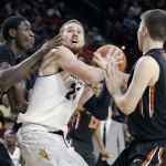 Arizona State's Eric Jacobsen, center, looks for a shot under the basket as Oregon State's Daniel Gomis, left, and Dylan Livesay defend during the second half of an NCAA college basketball game, Wednesday, Jan. 28, 2015, in Tempe, Ariz. Arizona State defeated Oregon State 73-55. (AP Photo/Ralph Freso)
