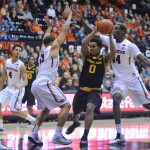 Arizona State's Tra Holder (0) drives against Oregon State's Daniel Gomis (14) and Malcolm Duvivier (11) during an NCAA college basketball game in Corvallis, Ore., Thursday Jan. 8, 2015. (AP Photo/Greg Wahl-Stephens)