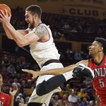 Arizona State's Eric Jacobsen, middle, jumps for a rebound between UNLV's Christian Wood (5) and Patrick McCaw, left, during the second half of an NCAA college basketball game Wednesday, Dec. 3, 2014, in Tempe, Ariz. Arizona State defeated UNLV 77-55. (AP Photo/Ross D. Franklin)