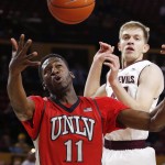 UNLV's Goodluck Okonoboh (11) grabs a rebound in front of Arizona State's Kodi Justice, right, during the first half of a college basketball game Wednesday, Dec. 3, 2014, in Tempe, Ariz. (AP Photo/Ross D. Franklin)