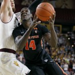 Oregon State forward Daniel Gomis (14) is guarded by Arizona State's Eric Jacobsen as he drives to the basket during the first half of an NCAA college basketball game, Wednesday, Jan. 28, 2015, in Tempe, Ariz. (AP Photo/Ralph Freso)
