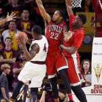 UNLV's Jelan Kendrick (22) and Goodluck Okonoboh, right, defend the basket so Arizona State's Gerry Blakes (4) is unable to get off a shot during the first half of a college basketball game Wednesday, Dec. 3, 2014, in Tempe, Ariz. (AP Photo/Ross D. Franklin)