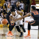 Arizona State guard Tra Holder, center, tries to dribble through the defense of Oregon State's Langston Morris-Walker (13) and Gary Payton II during the second half of an NCAA college basketball game, Wednesday, Jan. 28, 2015, in Tempe, Ariz. Arizona State defeated Oregon State 73-55. (AP Photo/Ralph Freso)
