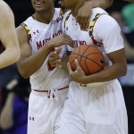 Maryland guard Melo Trimble, left, hugs Richaud Pack after Pack was fouled in the final minutes in the second half of the CBE Hall of Fame Classic college baseball game Arizona State Monday, Nov. 24, 2014, in Kansas City, Mo. Maryland won 78-73. (AP Photo/Ed Zurga)