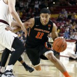 Oregon State guard Malcolm Duvivier (11) drives to the basket around the defense of Arizona State's Jonathan Gilling during the first half of an NCAA college basketball game, Wednesday, Jan. 28, 2015, in Tempe, Ariz. (AP Photo/Ralph Freso)
