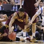 Arizona State's Jonathan Gilling, left, and Evan Gordon, center, scramble for a loose ball against UCLA's Travis Wear in the second half during a Pac-12 tournament NCAA college basketball game on Thursday, March 14, 2013, in Las Vegas. UCLA won 80-75. (AP Photo/Julie Jacobson)