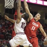 Arizona State's Evan Gordon shoots under pressure from Texas Tech's Kader Tapsoba, left, and Dejan Kravic (11) during an NCAA college basketball game in Lubbock, Texas, Saturday, Dec. 22, 2012. (AP Photo/Lubbock Avalanche-Journal, Zach Long)