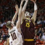 Arizona State's Jordan Bachynski (13) shoots as Utah's Renan Lenz (10) defends in the first half of an NCAA college basketball game, Sunday, Feb. 23, 2014, in Salt Lake City. (AP Photo/Rick Bowmer)