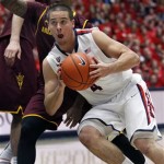  Arizona's T.J. McConnell (4) drives past Arizona State's Jahil Carson in the first half of an NCAA college basketball game on Thursday, Jan. 16, 2014, in Tucson, Ariz. (AP Photo/John Miller)