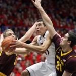  Arizona's Aaron Gordon, center, is sandwiched between Arizona's State's Jonathan Gilling, left, and Eric Koulechov (21) as he shoots for two points in the first half of an NCAA college basketball game on Thursday, Jan. 16, 2014, in Tucson, Ariz. (AP Photo/John Miller)