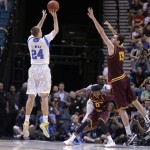 UCLA's Travis Wear puts up a three-point basket against Arizona State's Jordan Bachynski late in the game during a Pac-12 tournament NCAA college basketball gam on Thursday, March 14, 2013, in Las Vegas. UCLA won 80-75. (AP Photo/Julie Jacobson)