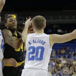 Arizona State guard Jermaine Marshall, center, is trapped by UCLA guard Zach LaVine, left, and guard Bryce Alford during the first half of an NCAA college basketball game in Los Angeles, Sunday, Jan. 12, 2014. (AP Photo/Chris Carlson)