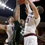 Colorado's Jaron Hopkins (23) gets double-teamed by Arizona State's Eric Jacobsen (21) and Jordan Bachynski, left, as he tries to go up for a shot during the first half of an NCAA college basketball game Saturday, Jan. 25, 2014, in Tempe, Ariz. (AP Photo/Ross D. Franklin)
