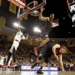 Utah's Princeton Onwas (3) collides with teammate Dallin Bachynski, right, after blocking the shot of Arizona State's Shaquielle McKissic, left, during the second half of an NCAA basketball game Thursday, Jan. 23, 2014, in Tempe, Ariz. Arizona State defeated Utah 79-75. (AP Photo/Ross D. Franklin)