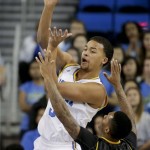 UCLA guard Kyle Anderson, left, passes over Arizona State guard Jahii Carson during the first half of an NCAA college basketball game in Los Angeles, Sunday, Jan. 12, 2014. (AP Photo/Chris Carlson)
