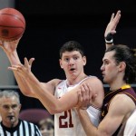 Arkansas' Hunter Mickelson (21) looks to pass the ball with Arizona State's Jordan Bachynski (13) defending during the first half of an NCAA college basketball game at the Continental Tire Las Vegas Invitational tournament on Friday, Nov. 23, 2012, in Las Vegas. (AP Photo/David Becker)