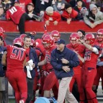 Arizona head coach Rich Rodriguez, center in blue, celebrates2nam defeating Oregon in the closing seconds of the second half of an NCAA college football game on Saturday, Nov. 23, 2013 in Tucson, Ariz. Arizona won 42 - 16. (AP Photo/John MIller)
