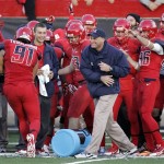 Arizona head coach Rich Rodriguez, center in blue, celebrates defeating Oregon in the closing seconds of the second half of an NCAA college football game on Saturday, Nov. 23, 2013 in Tucson, Ariz. Arizona won 42 - 16. (AP Photo/John MIller)