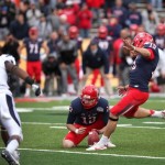 Arizona's John Bonano kicks the game-winning extra point as Kyle Dugandzic holds against Nevada during the final seconds of the New Mexico Bowl NCAA college football game against Nevada in Albuquerque, N.M., Saturday, Dec. 15, 2012. Arizona won 49-48. (AP Photo/Eric Draper)
