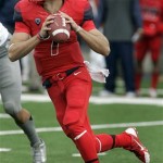  Arizona's quarterback B.J. Denker (7) looks to pass on the run against Oregon in the first half of an NCAA college football game on Saturday, Nov. 23, 2013, in Tucson, Ariz. (AP Photo/John MIller)