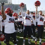 Arizona football players celebrate beating Boston College, 42-19, in the AdvoCare V100 Bowl NCAA college football game, Tuesday, Dec. 31, 2013, at Independence Stadium in Shreveport, La. (AP Photo/Rogelio V. Solis)
