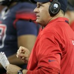 Arizona's head coach Rich Rodriguez looks at the game clock during a timeout against Utah in the first half of an NCAA collge football game, Saturday, Oct. 19, 2013 in Tucson, Ariz. (AP Photo/John Miller) 