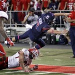 Arizona quarterback B.J. Denker (7) is pushed out of bounds by Utah's Trevor Reilly (9) short of the end zone in the first half of an NCAA college football game, Saturday, Oct. 19, 2013, in Tucson, Ariz. (AP Photo/Wily Low)