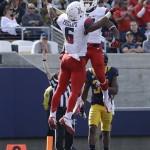 Arizona wide receiver Nate Phillips (6) celebrates after scoring on a 21-yard touchdown reception with wide receiver Samajie Grant during the second quarter of an NCAA college football game against California in Berkeley, Calif., Saturday, Nov. 2, 2013. (AP Photo/Jeff Chiu)
