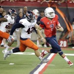 Arizona's starting quarterback B.J. Denker (7) runs pass Texas San Antonio's Jens Jeters (42) and Andre Brown (20) for a touchdown in the first quarter of an NCAA Football game in Tucson, Ariz. on Saturday Sept. 14, 2013. (AP Photo/Wily Low)
