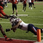 Arizona wide receiver Austin Hill (29) dives in for a touch down as a Utah player looks on in the fourth quarter during an NCAA college football Saturday, Nov. 17, 2012, in Salt Lake City. Arizona defeated Utah 34-24. (AP Photo/Rick Bowmer)
