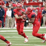  Arizona's starting quarterback B.J. Denker (7) hands off the ball to Ka'Deem Carey (25) in the first half of an NCAA college football game against Oregon, Saturday, Nov. 23, 2013 in Tucson, Ariz. (AP Photo/Wily Low)
