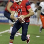 Arizona's starting quarterback B.J. Denker looks to pass out of the backfield against Texas San Antonio in the first half of an NCAA college football game, Saturday, Sept. 14, 2013 in Tucson, Ariz. (AP Photo/john Miller) 