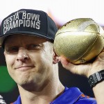 Boise State head coach Bryan Harsin holds up the Champions Trophy after the Fiesta Bowl NCAA college football game against Arizona, Wednesday, Dec. 31, 2014, in Glendale, Ariz. Boise State won 38-30. (AP Photo/Ross D. Franklin)