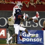 Arizona cornerback Jonathan McKnight defends on an incomplete pass to UNLV wide receiver Kendal Keys, top, during the first half of an NCAA college football game, Friday, Aug. 29, 2014, in Tucson, Ariz. (AP Photo/Rick Scuteri)