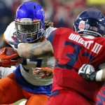 Boise State running back Jay Ajayi (27) eyes Arizona linebacker Scooby Wright III (33) during the first half of the Fiesta Bowl NCAA college football game, Wednesday, Dec. 31, 2014, in Glendale, Ariz. (AP Photo/Ross D. Franklin)