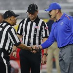 Boise State head coach Bryan Harsin greets the officials prior to the Fiesta Bowl NCAA college football game against Arizona, Wednesday, Dec. 31, 2014, in Glendale, Ariz. (AP Photo/Rick Scuteri)