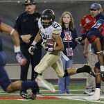 Colorado running back Phillip Lindsay (23) runs for a first down during the first half of an NCAA college football game against Arizona, Saturday, Nov. 8, 2014, in Tucson, Ariz. (AP Photo/Rick Scuteri)
